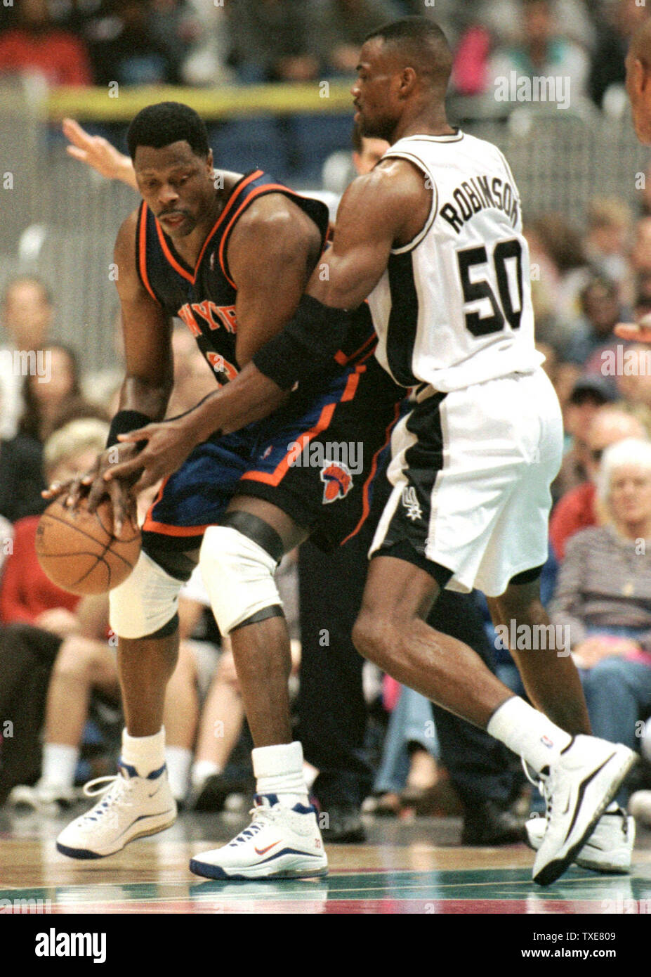 SAP2000012204 - 22 JANUARY 2000 - SAN ANTONIO, TEXAS, USA:  Patrick Ewing (33) of the New York Knicks tries to get past San Antonio Spurs David Robinson (50) during second quarter action at the Alamodome. The Spurs defeated the Knicks 96-83, Jaunary 22, in a rematch of last year's NBA finals.   rg/jm/Joe Mitchell UPI Stock Photo