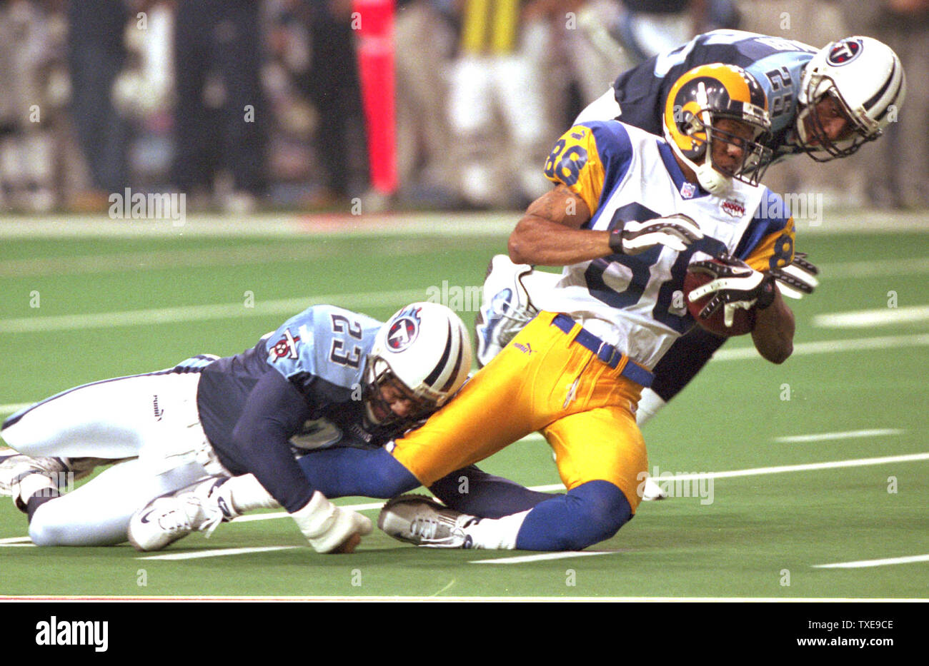 ATL2000013026 - 30 JANUARY 2000 - ATLANTA, GEORGIA, USA: Rams Torry Holt (88) is tackled by Titans Blain Bishop (23) and Denard Walker in Super Bowl XXXIV.  rw/ts/Susan Knowles   UPI Stock Photo