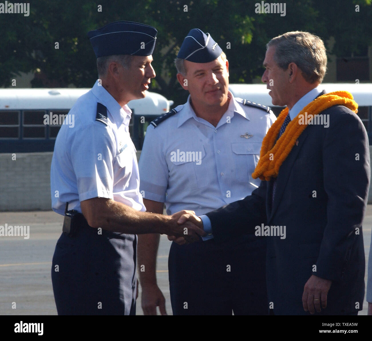 George W. Bush, the 43rd President of the United States, arrives at Hickam Air Force Base, Hawaii, on Oct. 23, 2003.  Col. Raymond G. Torres, the commander of the 15th Airlift Wing, Hickam Air Force Base and Gen. William J. Begert, Commander, Pacific Air Forces, and Air Component Commander for the Commander, U.S. Pacific Command, Hickam Air Force Base, welcomes the President at Base Operations.  (UPI/Mysti Cabasug/AFIE) Stock Photo