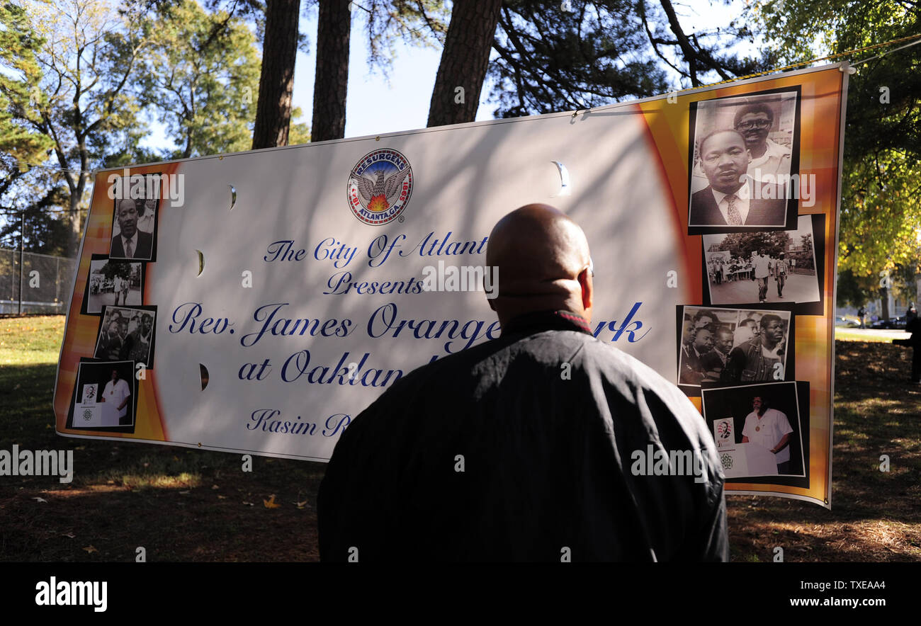 Larry Avery looks at a banner for the late Rev. James Orange, a civil