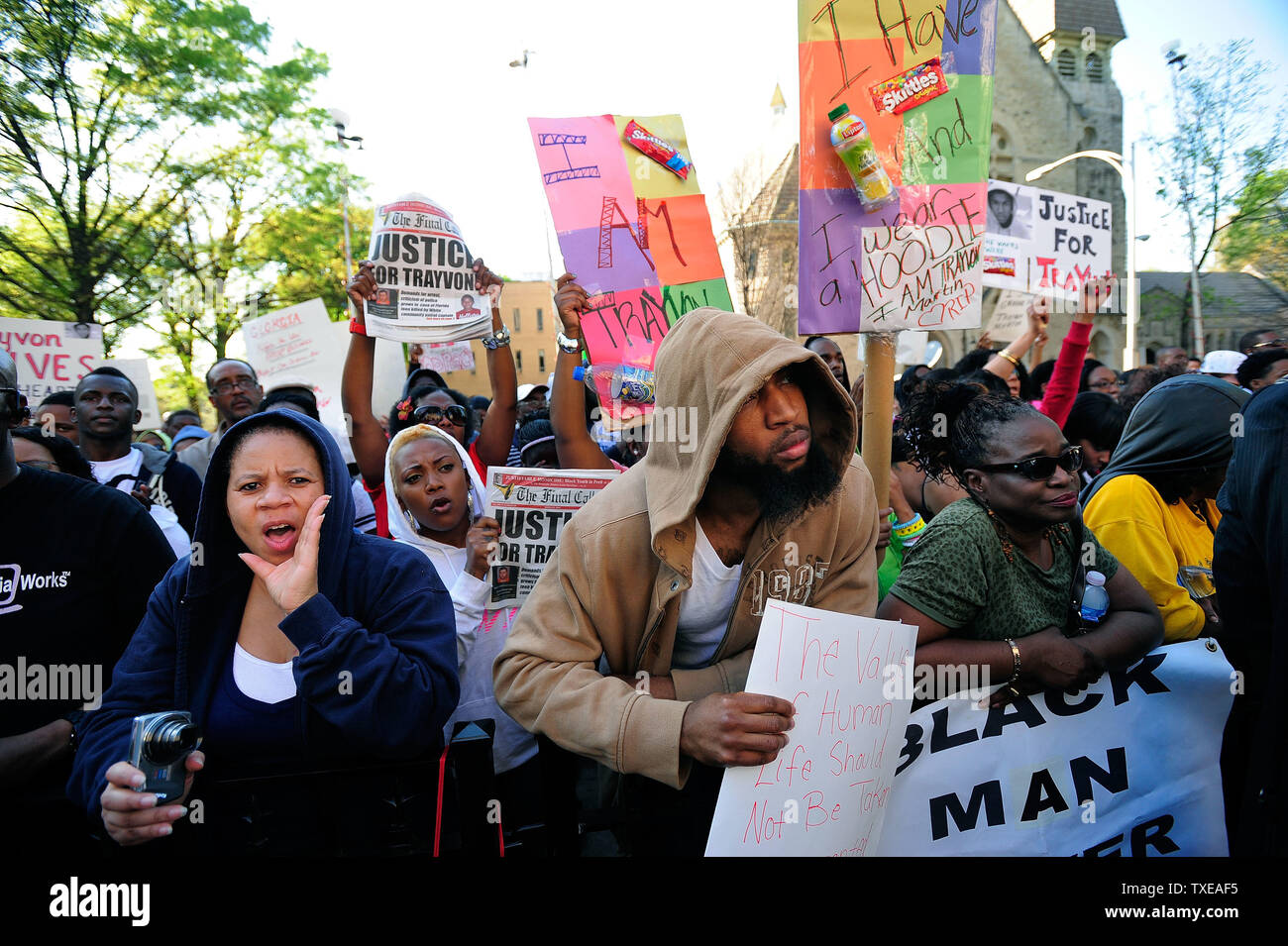 El-Regina Harrison, left, Edward Bruno-Gaston, center, and Ruby Bozeman-Davis, right, join several thousand students from historically black universities and local residents, some wearing hoodies, at a rally for slain youth Trayvon Martin in front of the state Capitol in Atlanta on March 26, 2012. A Capitol policeman said it was the largest rally in recent memory and several downtown streets were closed down, snarling the evening rush hour.    UPI/David Tulis Stock Photo