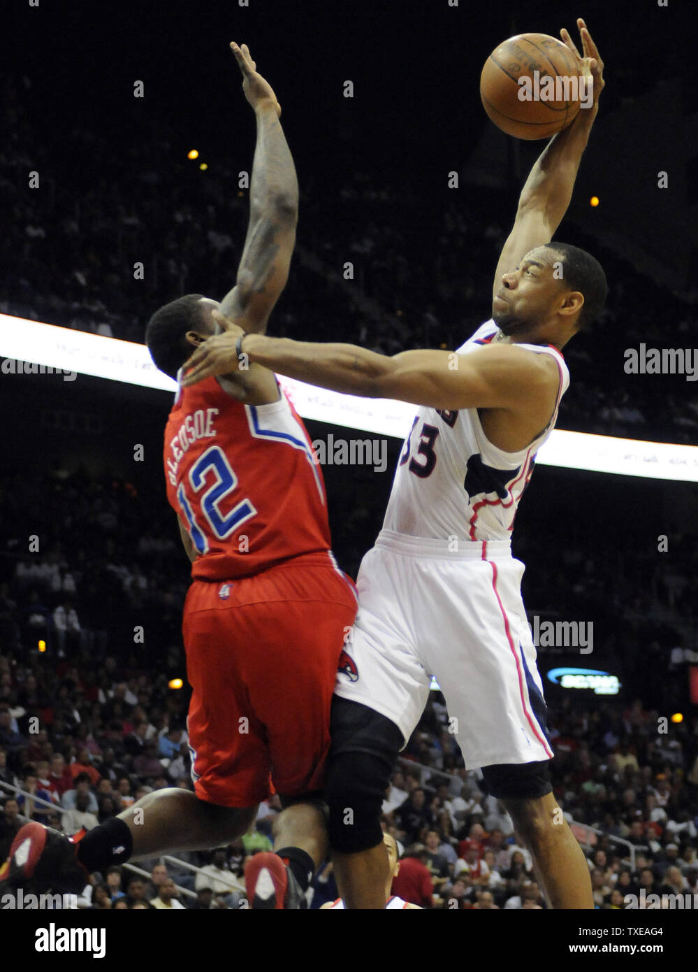 Atlanta Hawks guard Willie Green (33) goes over Los Angeles Clippers point guard Eric Bledsoe (12) in the second half at Philips Arena in Atlanta on April 24, 2012. UPI/David Tulis Stock Photo