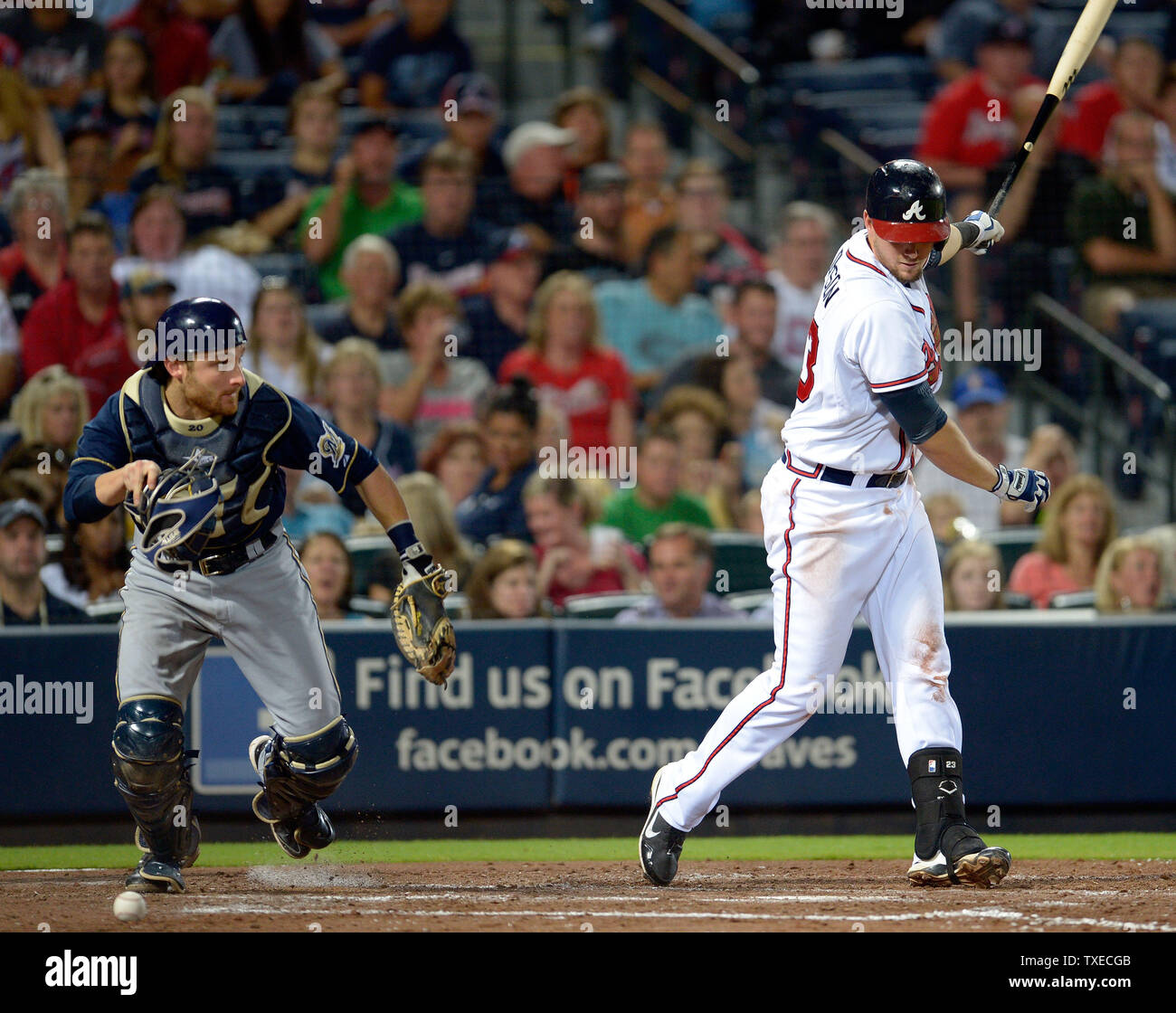 Milwaukee Brewers catcher Jonathan Lucroy (L) scrambles for the wild