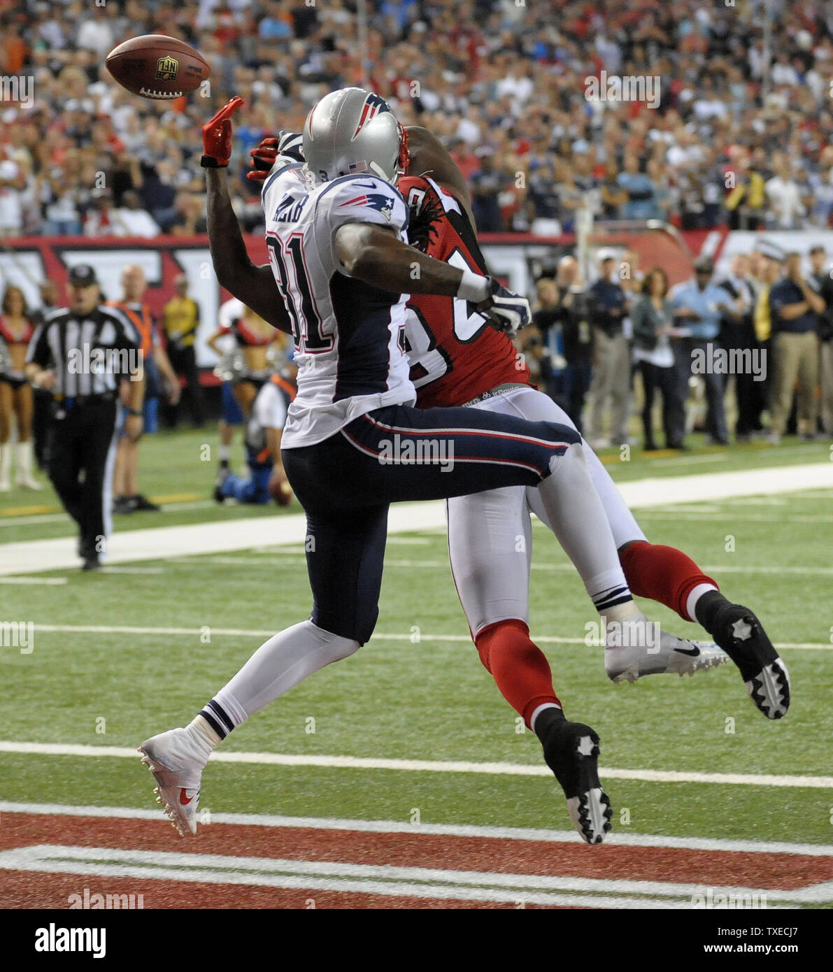 New England Patriots quarterback Tom Brady (12) sails after being hit by Denver  Broncos cornerback Aqib Talib on a first down run in the second quarter  during the AFC Championship game at