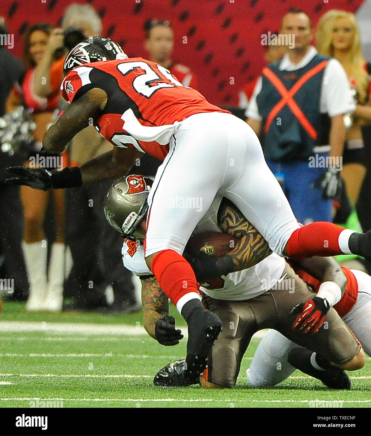 Atlanta Falcons defenders William Moore (25) and Joplo Bartu (R) stop Tampa  Bay Buccaneers' Tom Crabtree (84) during the first half at the Georgia Dome  in Atlanta on October 20, 2013. Crabtree