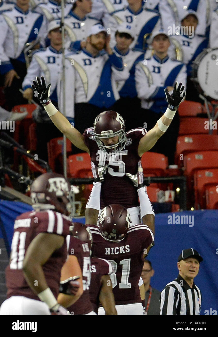 Texas A&M wide receiver Travis Labhart (15) celebrates his 9-yard touchdown catch over Duke with teammate Nehemiah Hicks during the first half of the Chick-fil-A Bowl football game at the Georgia Dome on December 31, 2013. UPI/David Tulis Stock Photo