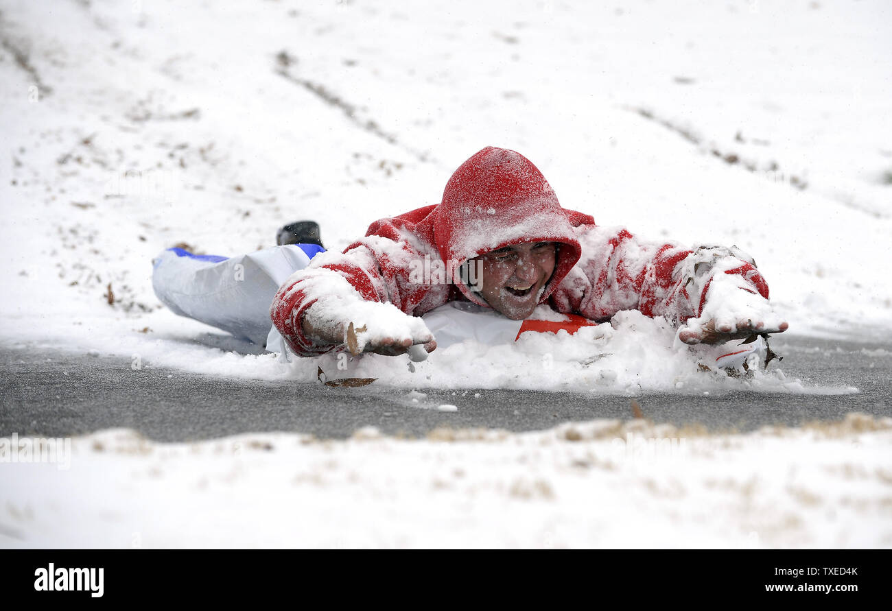 Cooper Gouge slides down hill at Piedmont Park as a major winter storm  dumps 1 to 3 inches of snow on Atlanta, January 28, 2014. UPI/David Tulis  Stock Photo - Alamy, image size:1300x891