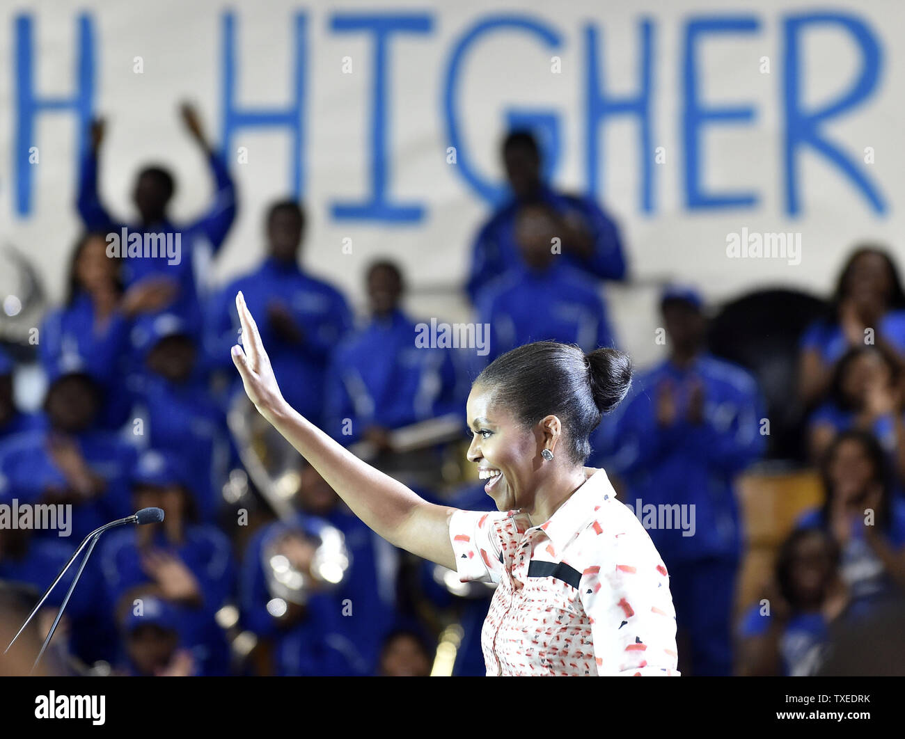 First Lady Michelle Obama waves to the crowd gathered at Booker T. Washington high school during a Reach Higher education rally with students on September 8, in Atlanta. UPI/David Tulis Stock Photo