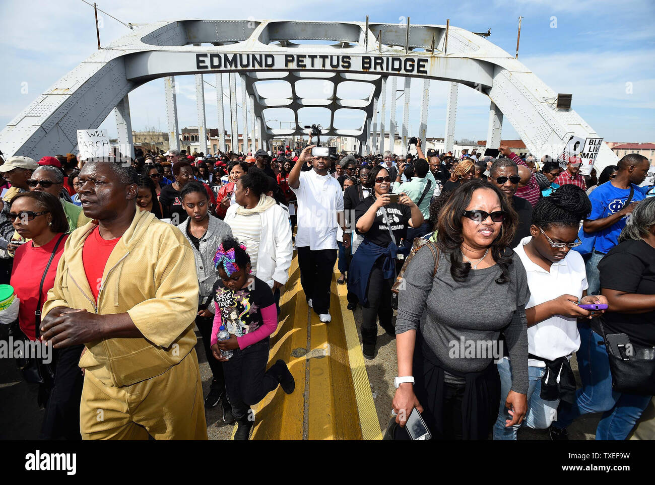 Thousands of marchers cross the historic Edmund Pettus Bridge to