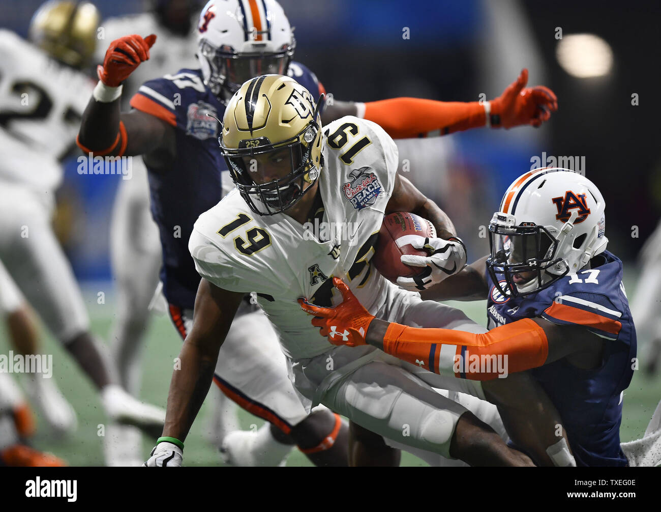 University of Central Florida Knights kick returner Mike Hughes (19) is tackled by Auburn defenders during the Chick-fil-A Peach Bowl NCAA football game at the Mercedes-Benz Stadium in Atlanta on January 1, 2018. Photo by David Tulis/UPI Stock Photo