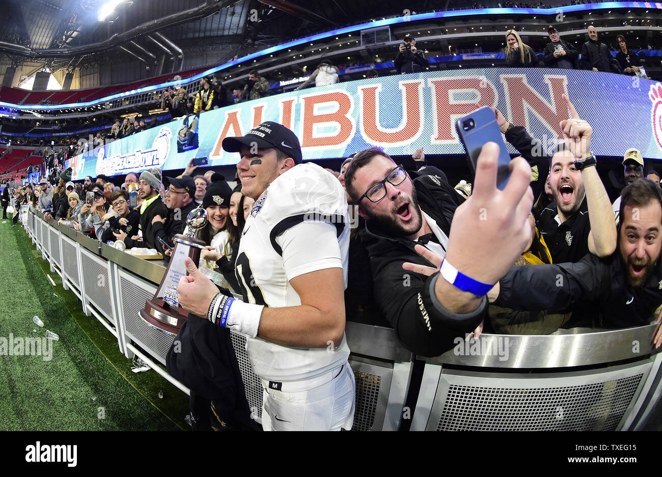 Fans swarm University of Central Florida Knights quarterback McKenzie Milton after the Chick-fil-A Peach Bowl NCAA football game at the Mercedes-Benz Stadium in Atlanta on January 1, 2018. UCF won 34-27 to go undefeated for the season. Photo by David Tulis/UPI Stock Photo