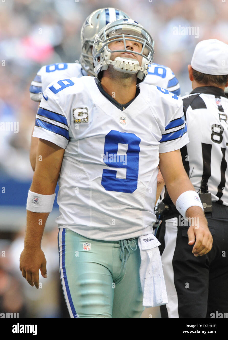 Dallas Cowboys Tony Romo looks up at the video board after being sacked ...