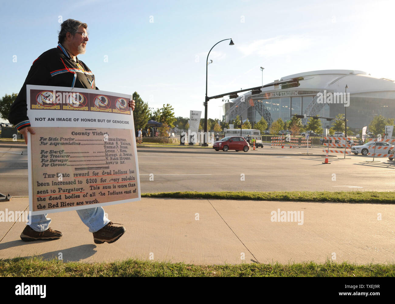 Protesters wanting a chance to the Washington Redskins mascot name hold signs outside AT&T Stadium prior to the Dallas Cowboys and Washington Redskins game on October 27, 2014 in Arlington, Texas.     UPI/Ian Halperin Stock Photo