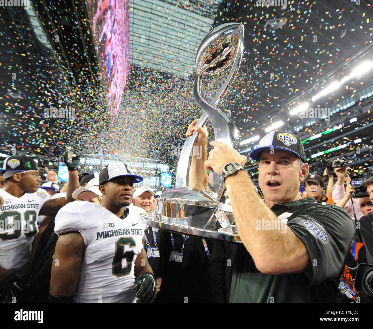 Michigan State head coach Mark Dantonio accepts the Field Scovell trophy after defeating the Baylor Bears 42-41 in the Goodyear Cotton Bowl Class in AT&T Stadium, Arlington, Texas on January 1, 2015.  Ian Halperin/UPI Stock Photo