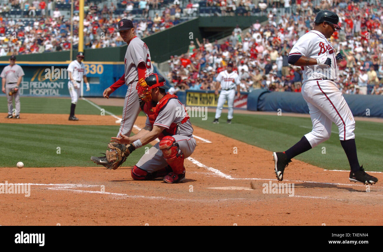 Atlanta Braves Andruw Jones beats a throw to home to score a run against the Boston Red Sox in the eighth inning June 17, 2006, in Atlanta's Turner Field. Boston catcher Jason Varitek waits for the throw.The Red Sox defeated the Braves 5-3 (UPI Photo/John Dickerson) Stock Photo