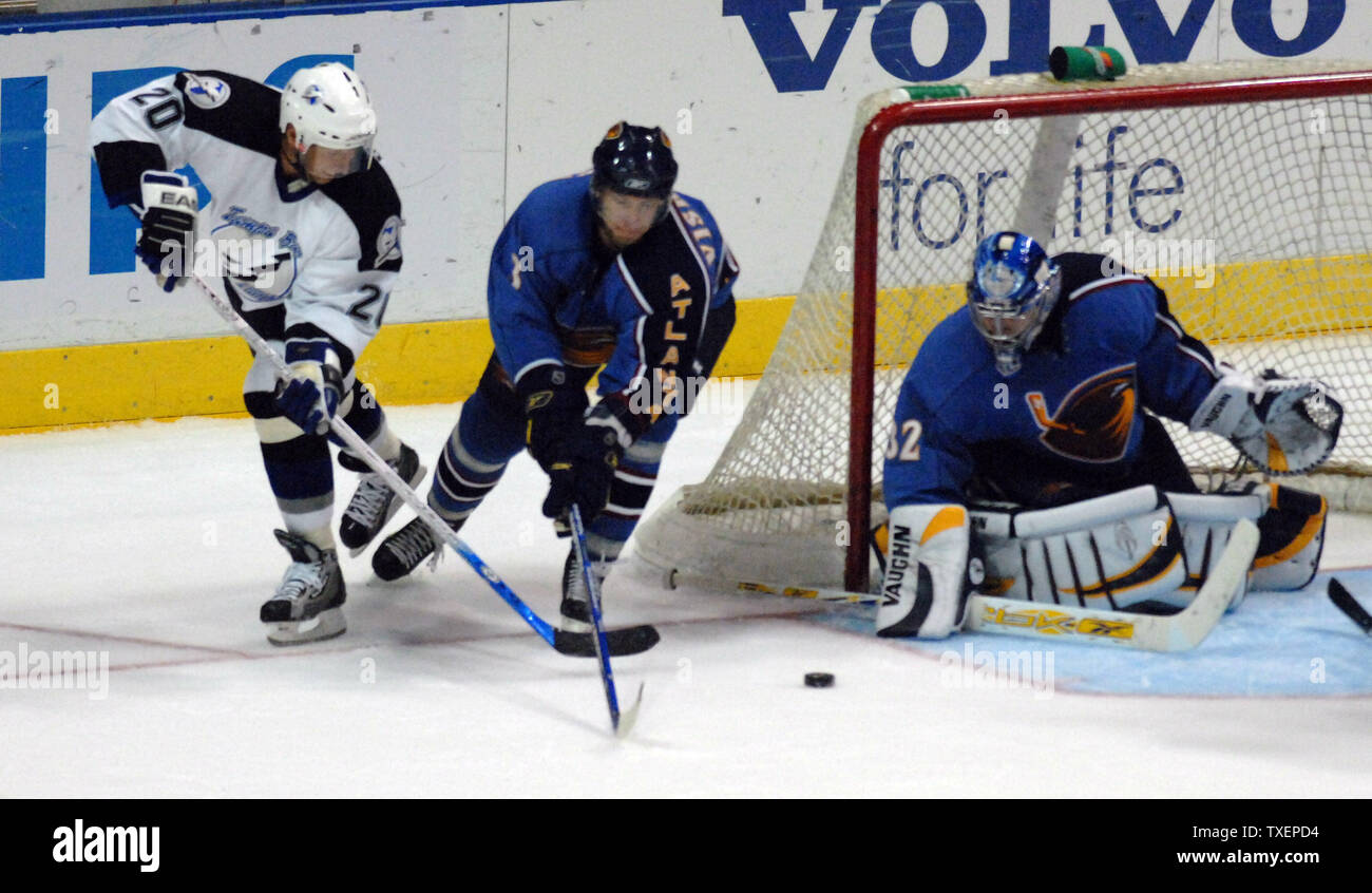 Atlanta Thrashers defenseman Vitaly Vishnevski (center) and goalie Kari