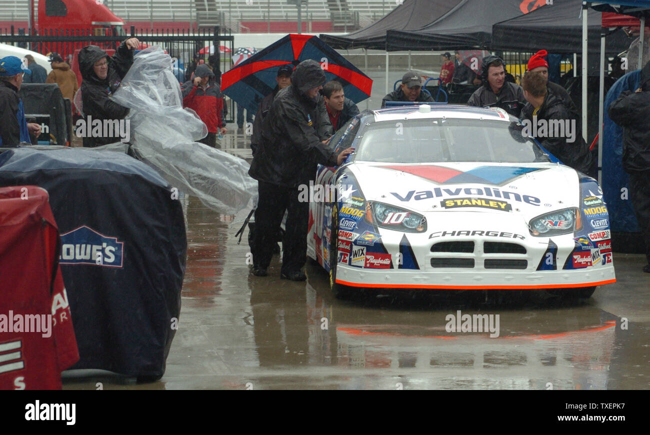 The Car Of Scott Riggs Is Pushed Through The Rainy Garage Area