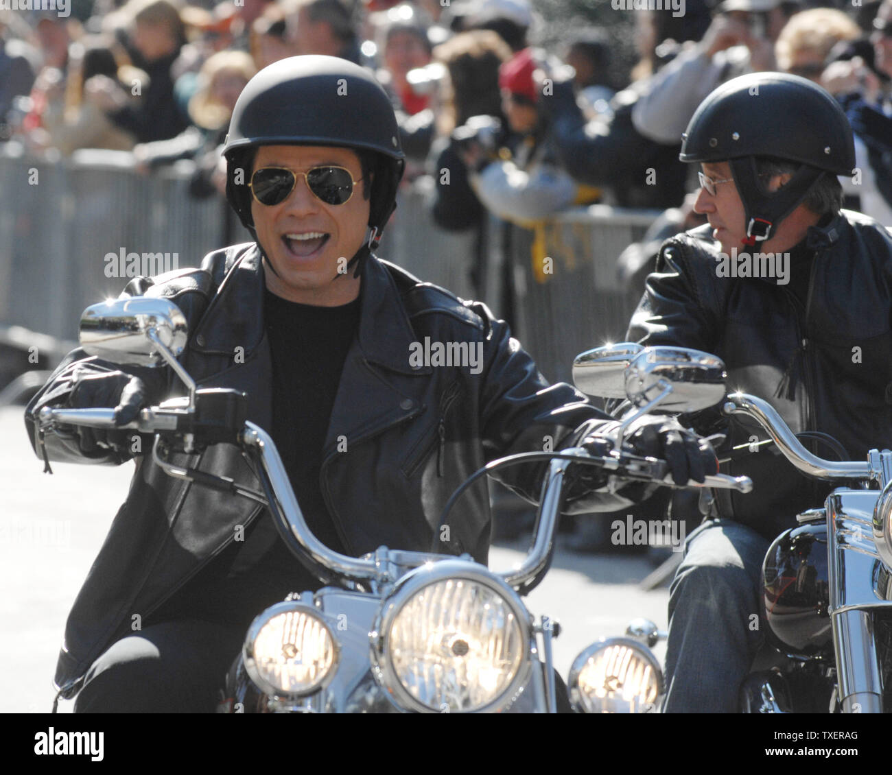 'Wild Hogs' stars John Travolta (L) and Tim Allen ride slowly on motorcycles at the Georgia State Capitol on February 6, 2007. The actors promoted a motorcycle safety program and their upcoming comedy film. (UPI Photo/John Dickerson) Stock Photo
