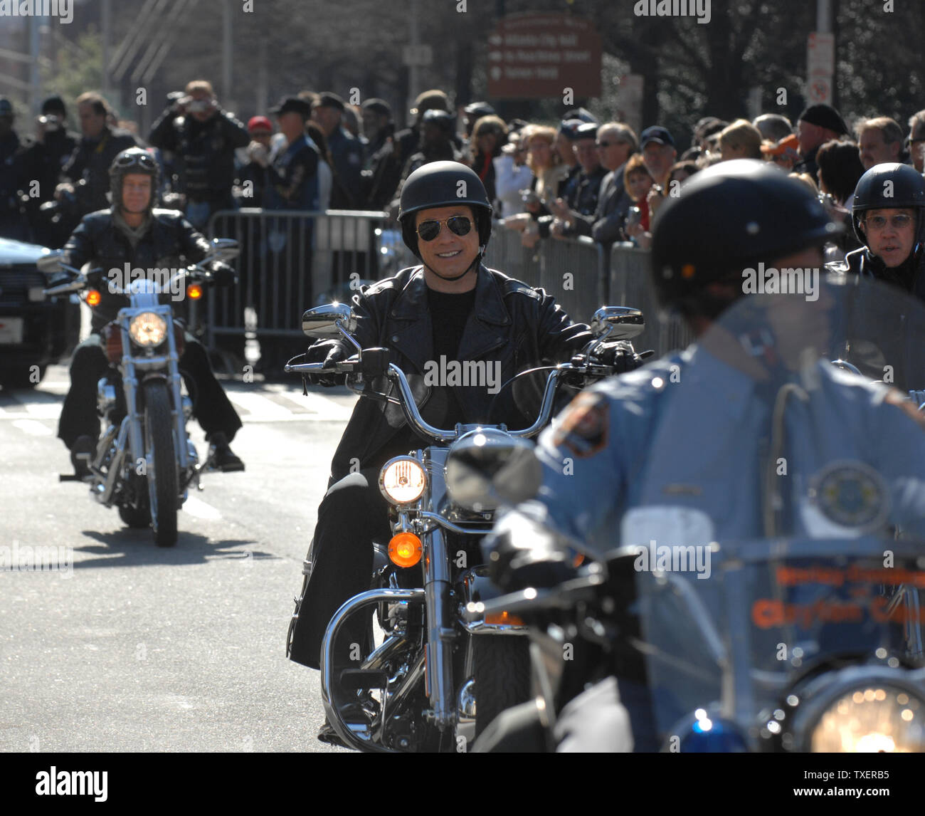 'Wild Hogs' stars John Travolta (C) and Tim Allen ride behind a Georgia State Patrol officer at the Georgia State Capitol on February 6, 2007. The actor promoted a motorcycle safety program and their upcoming comedy film. (UPI Photo/John Dickerson) Stock Photo