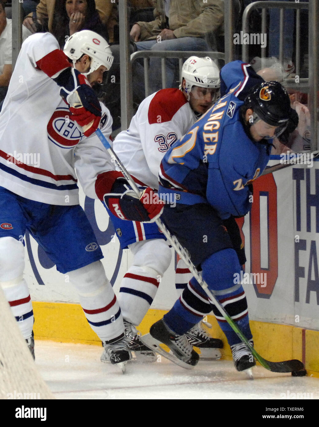 Montreal Canadiens Sheldon Souray (44) and teammate Mark Streit (32) of Switzerland battle with Atlanta Thrashers Eric Belanger (22) for the puck in the third period at Philips Arena in Atlanta, March 8, 2007.  The Thrashers defeated the Canadiens 6-2. (UPI Photo/John Dickerson) Stock Photo