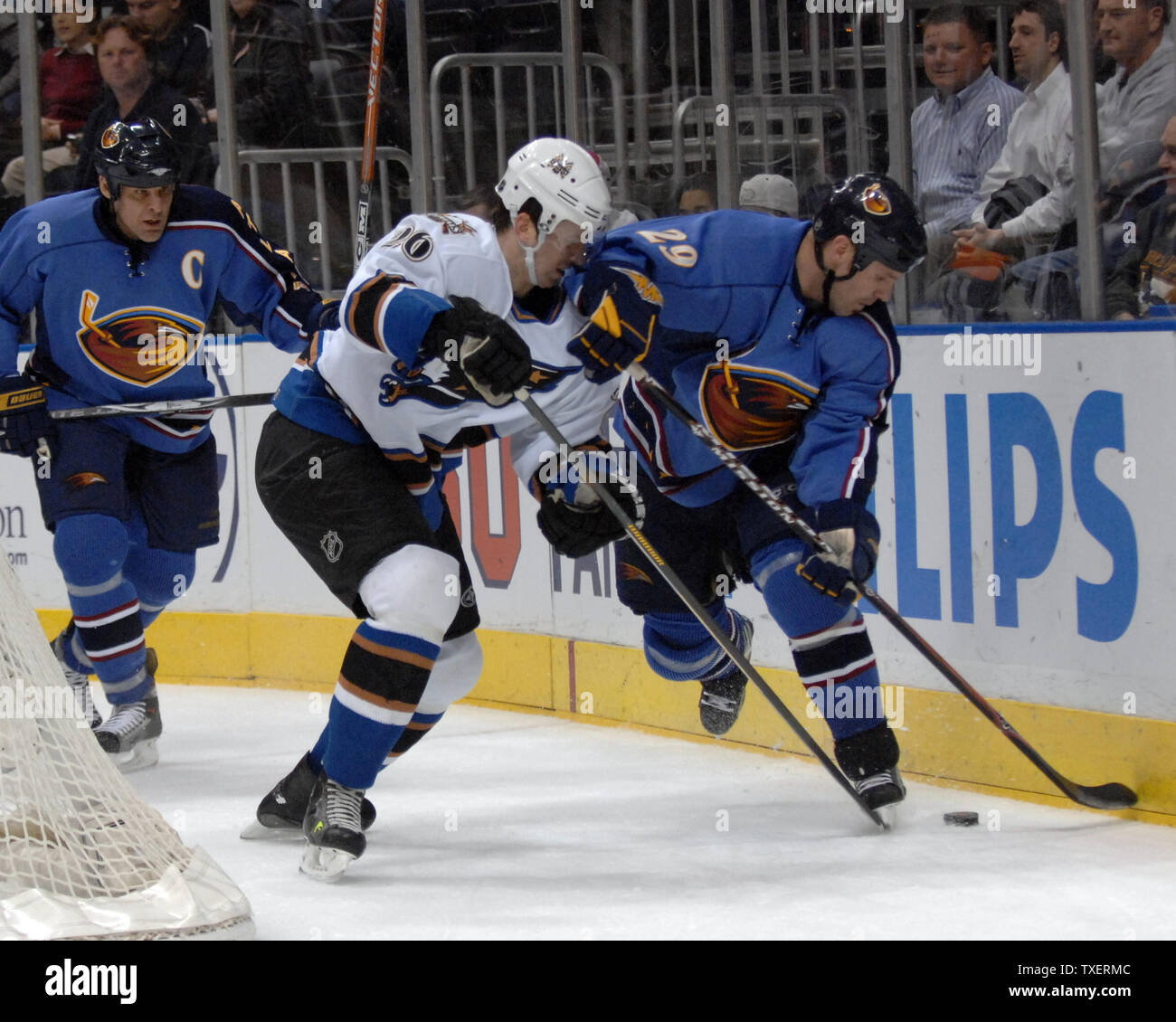 Washington Capitals Shaone Morrisonn (26) and Atlanta Thrashers Brad Larsen (29) fight for the puck in the first period at Philips Arena in Atlanta, March 12, 2007. (UPI Photo/John Dickerson) Stock Photo