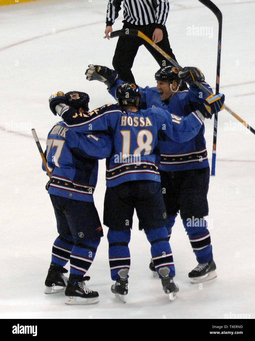 Atlanta Thrashers Alexei Zhitnik (left) of Ukraine is mobbed by teammates Marian Hossa (18) of Slovakia and Keith Tkachuk after he hit the game-winning goal in overtime to defeat the New York Rangers at Philips Arena in Atlanta, March 16, 2007. (UPI Photo/John Dickerson) Stock Photo