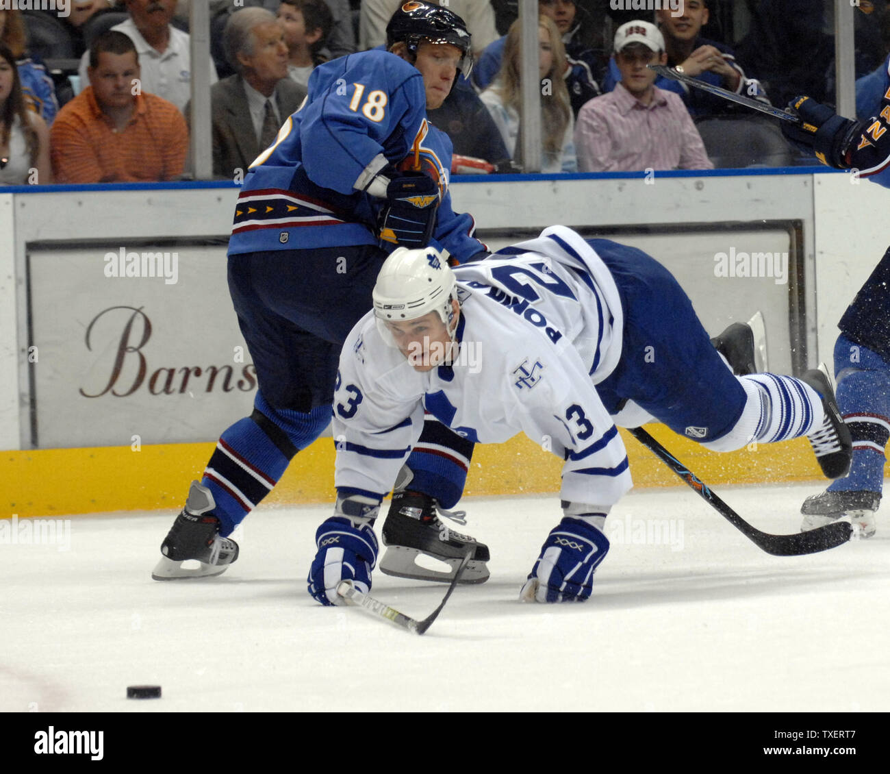 Toronto Maple Leafs Alexei Ponikarovsky (23) of Ukraine crashes to the ice over the stick of Atlanta Thrashers Marian Hossa (18) of Slovakia in pursuit of the puck in the first period at Philips Arena in Atlanta on March 29, 2007.  (UPI Photo/John Dickerson) Stock Photo