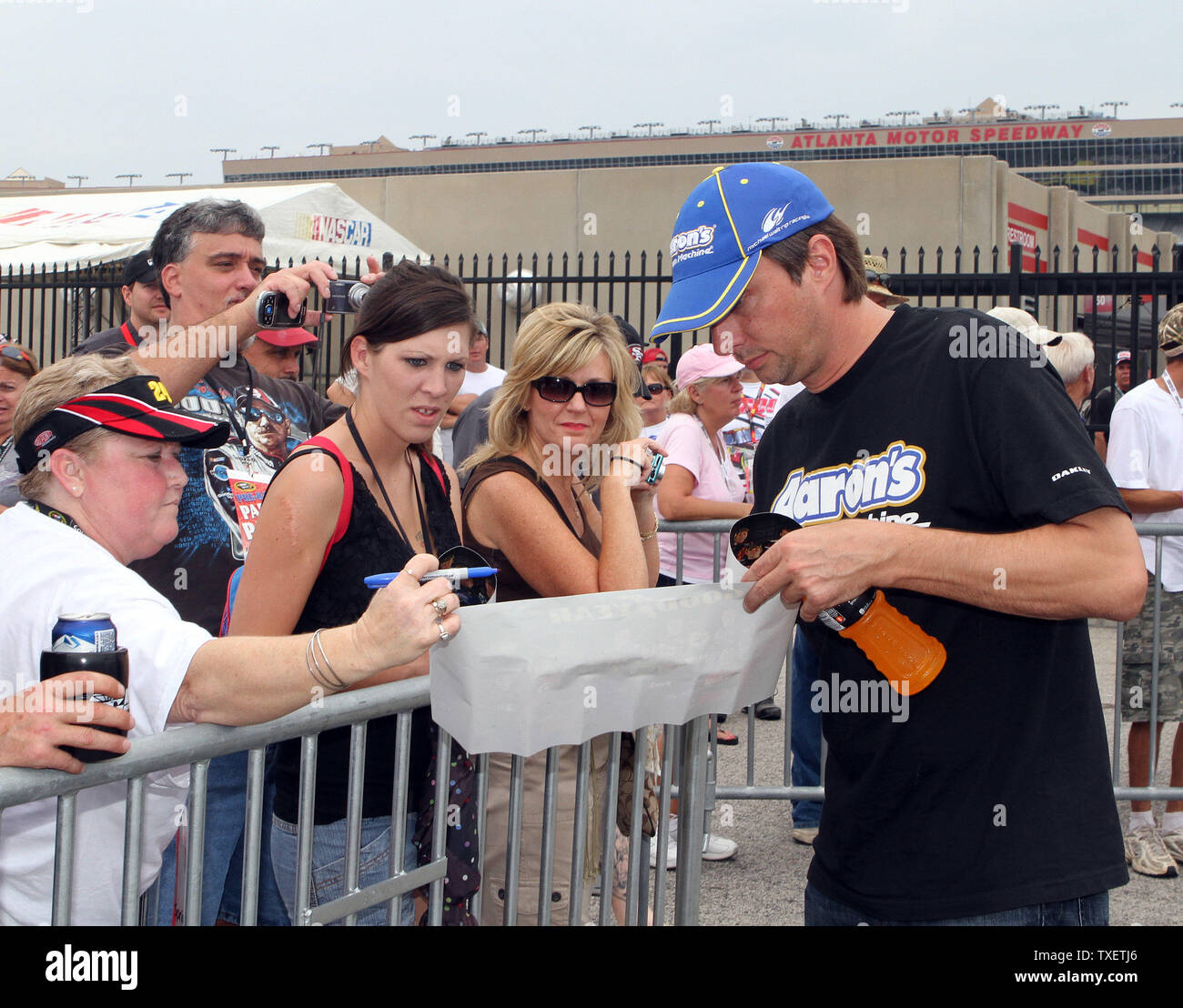 David Reutimann (R) signs autographs for fans prior to the start of the 52 Annual AdvoCare 500 at Atlanta Motor Speedway Speedway in Hampton, Georgia on September 4, 2011.  UPI/Martin Fried Stock Photo