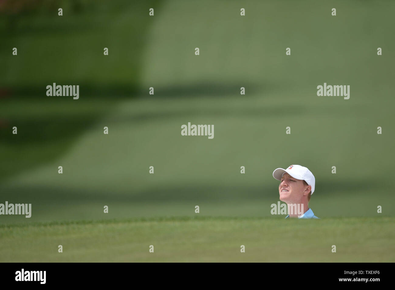 Jordan Niebrugge peers over a hill as he watches his ball roll on the seventh green during a practice round prior to the Masters golf tournament at Augusta National Golf Club in Augusta, George, April 8, 2014.  UPI/Kevin Dietsch Stock Photo