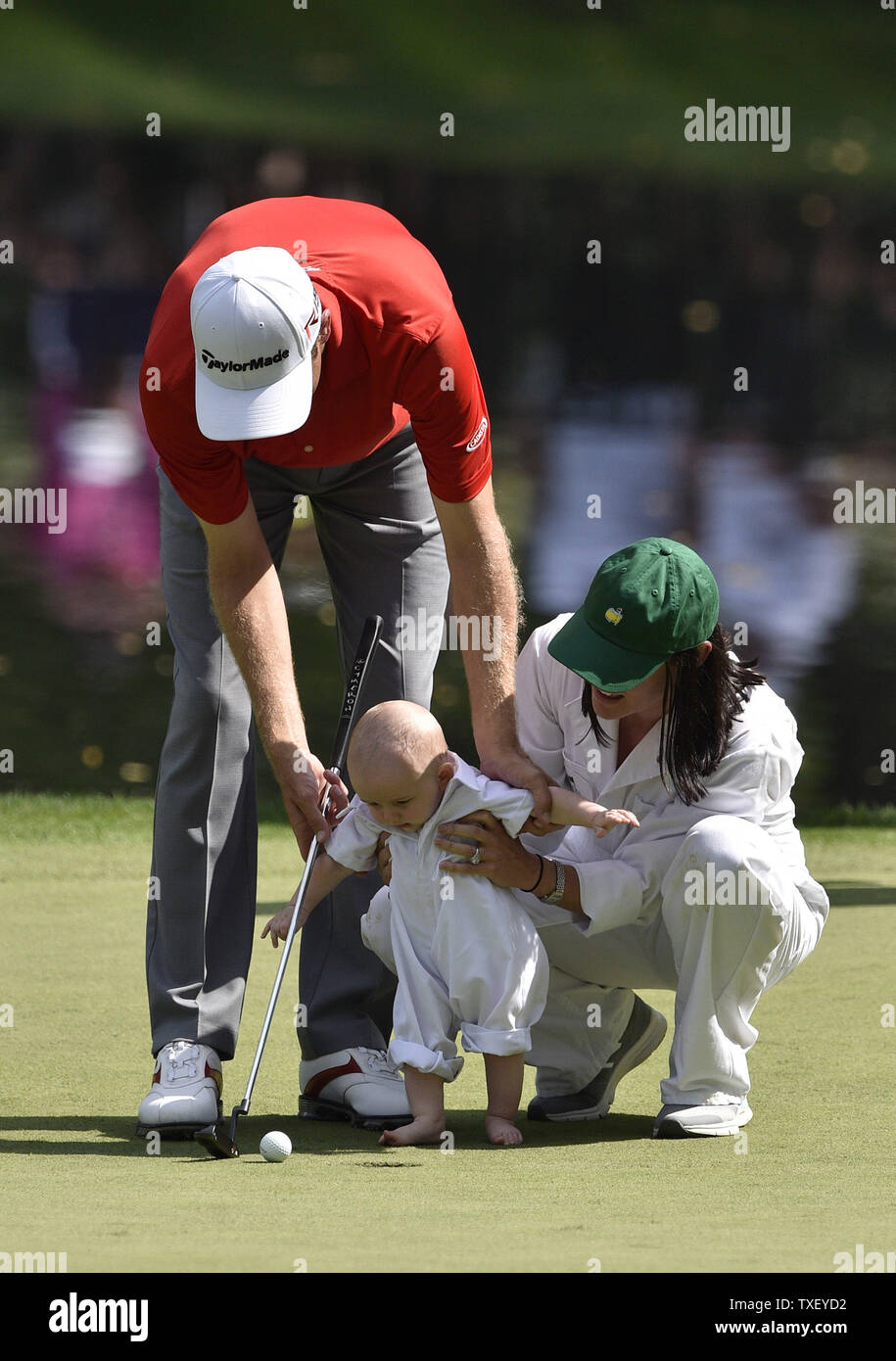 Brendon Todd and his wife Rachel Todd help their son Oliver putt on the