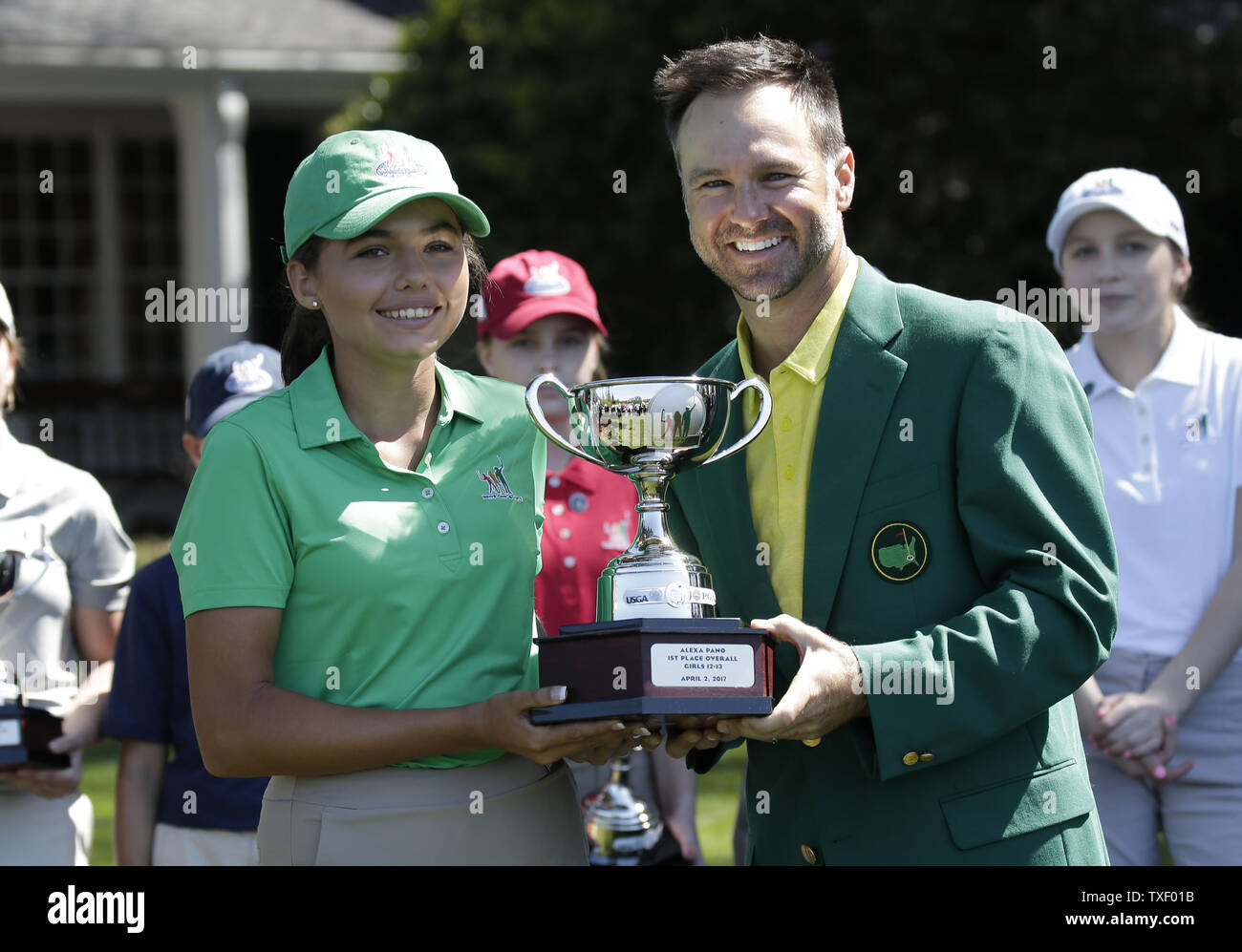 Past Masters champion Trevor Immelman stands with Alexa Pano who wins the  overall in the Drive, Chip & Putt Championship for Girls age 12-13 at the  2017 Masters Tournament at Augusta National