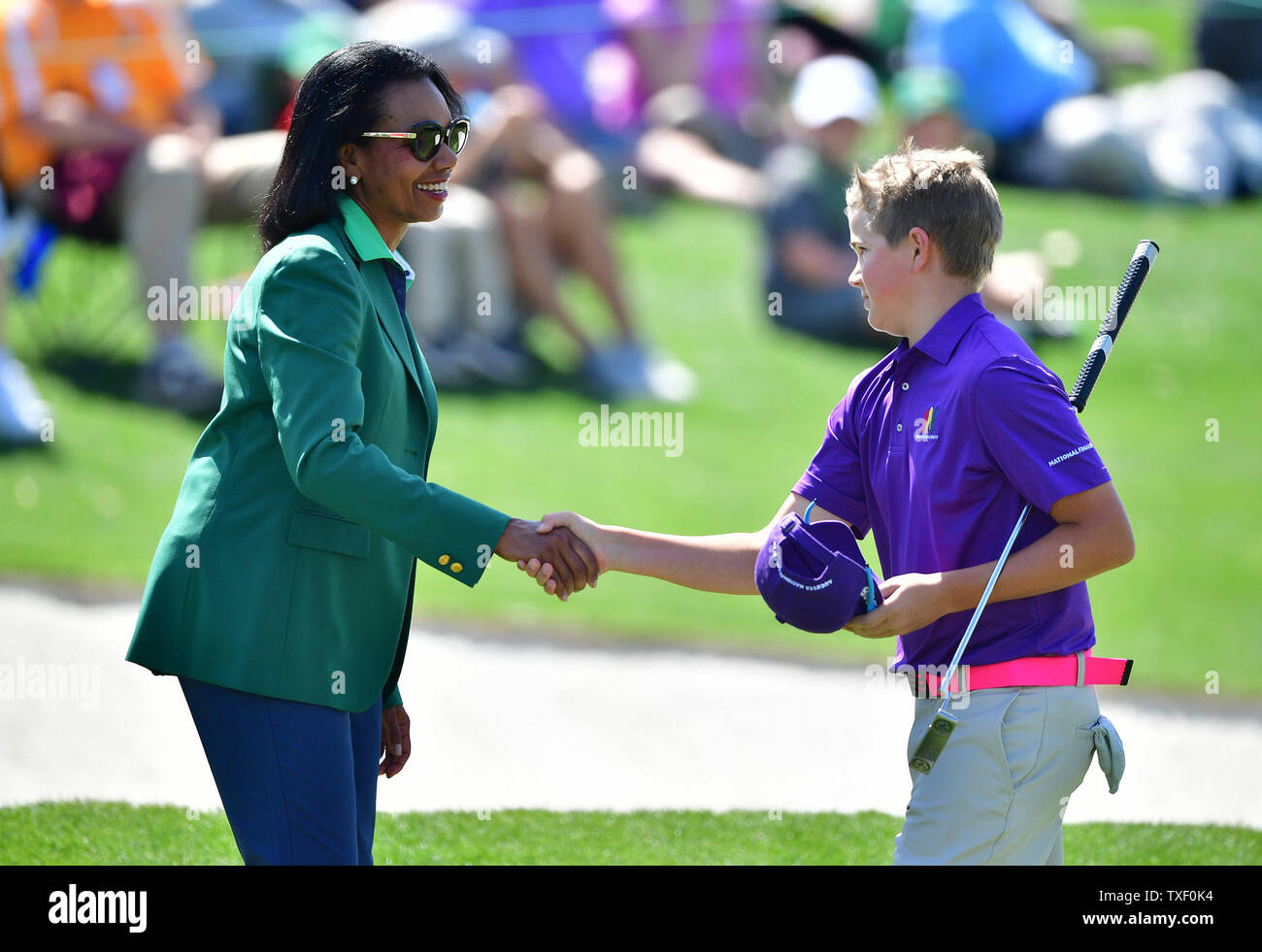 P.J. May bank III shakes hands with former Secretary of State Condoleezza Rice during the Drive Chip & Putt National Finals at Augusta National Golf Club during Masters week on April 1, 2018 in Augusta, Georgia. Photo by Kevin Dietsch/UPI Stock Photo