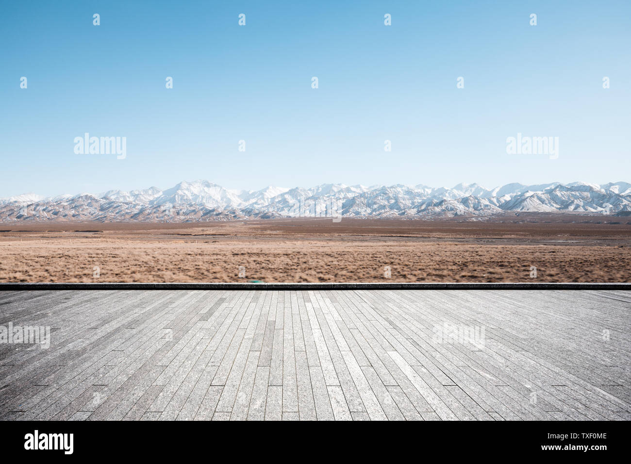 Empty brick floor with snow mountains Stock Photo