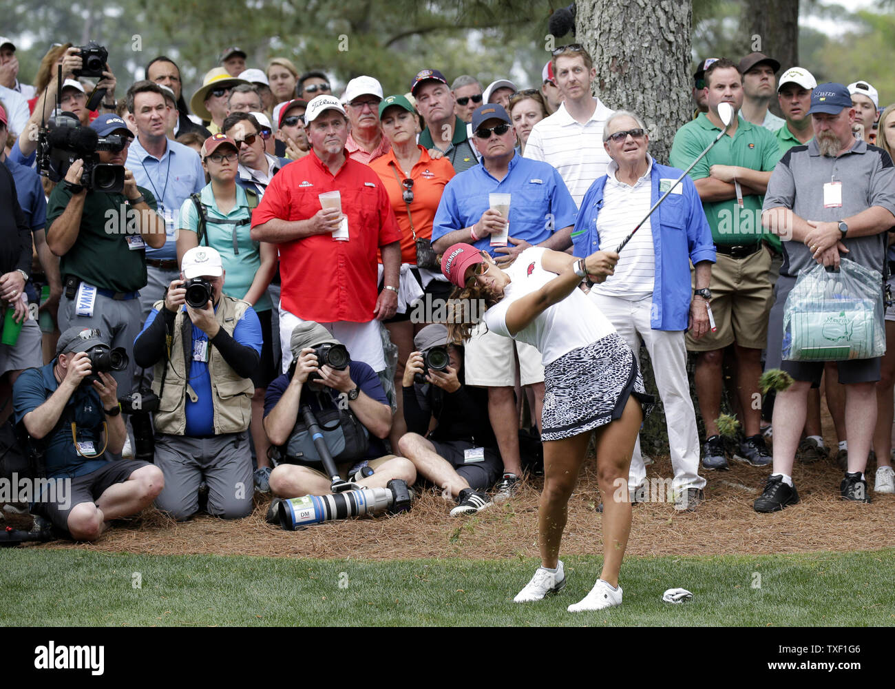 Patrons watch Maria Fassi of Mexico as she hits from the rough in the final round of the Augusta National Womens Amateur at the Augusta National Golf Club in Augusta, Georgia, on picture