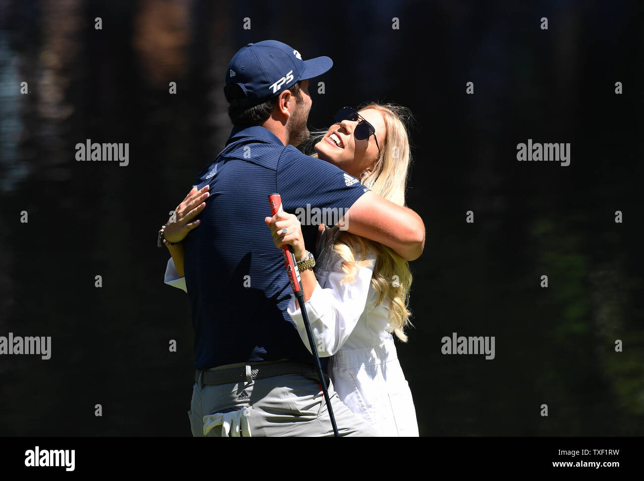 Jon Rahm hugs girlfriend Kelley Cahill at the Par 3 Contest on the Wednesday before the 2019 Masters Tournament at Augusta National Golf Club in Augusta, Georgia, on April 10, 2019.      Photo by Kevin Dietsch/UPI Stock Photo
