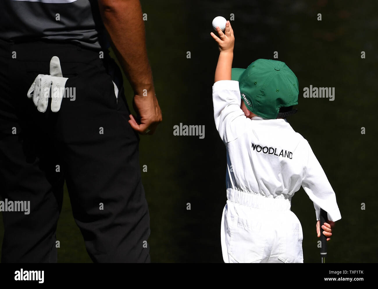 Gary Woodland's son Jaxson Lynn Woodland throws a ball into the water