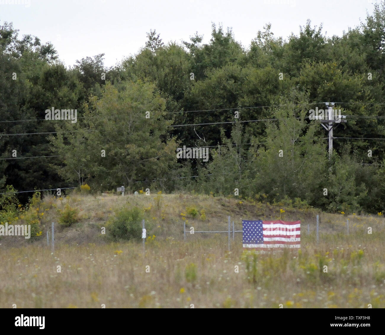 An American flag marks the crash site of Flight 93 that crashed near Shanksville,  Pennsylvania after the plane hijacking of the September 11, 2001 terrorist attacks, during the eighth anniversary ceremony on September 11, 2009.  UPI/Archie Carpenter Stock Photo