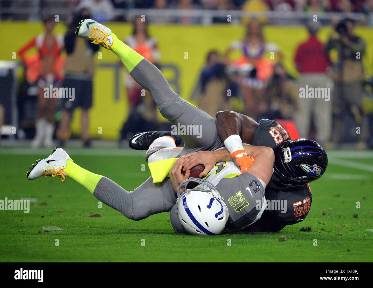 Indiana Colts quarterback Andrew Luck is sacked by Baltimore Ravens linebacker Elvis Dumervil during the Pro Bowl at University of Phoenix Stadium in Glendale, Arizona on January 24, 2015.  Photo byKevin Dietsch/UPI Stock Photo