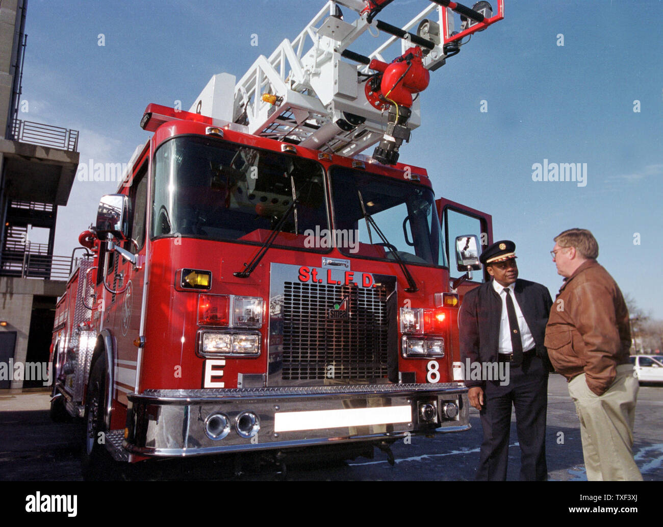 SLP2000020308 - 02 FBRUARY 2000 - ST. LOUIS, MISSOURI, USA:  St. Louis Fire Chief Sherman George, left, talks with fleet maintaince manager Dave Ryder during the delivery of the first of 30 new fire trucks, February 3. The pumper, manufactured by Smeal Fire Apparatus in Nebraska, is priced at $412 thousand and offers seating for seven, a 75-foot aerial ladder and twice the pumping capability of the 1987 Pierce or LTI models now in service. All of the new trucks will be in service in the next 18 months.  rg/bg/Bill Greenblatt    UPI Stock Photo