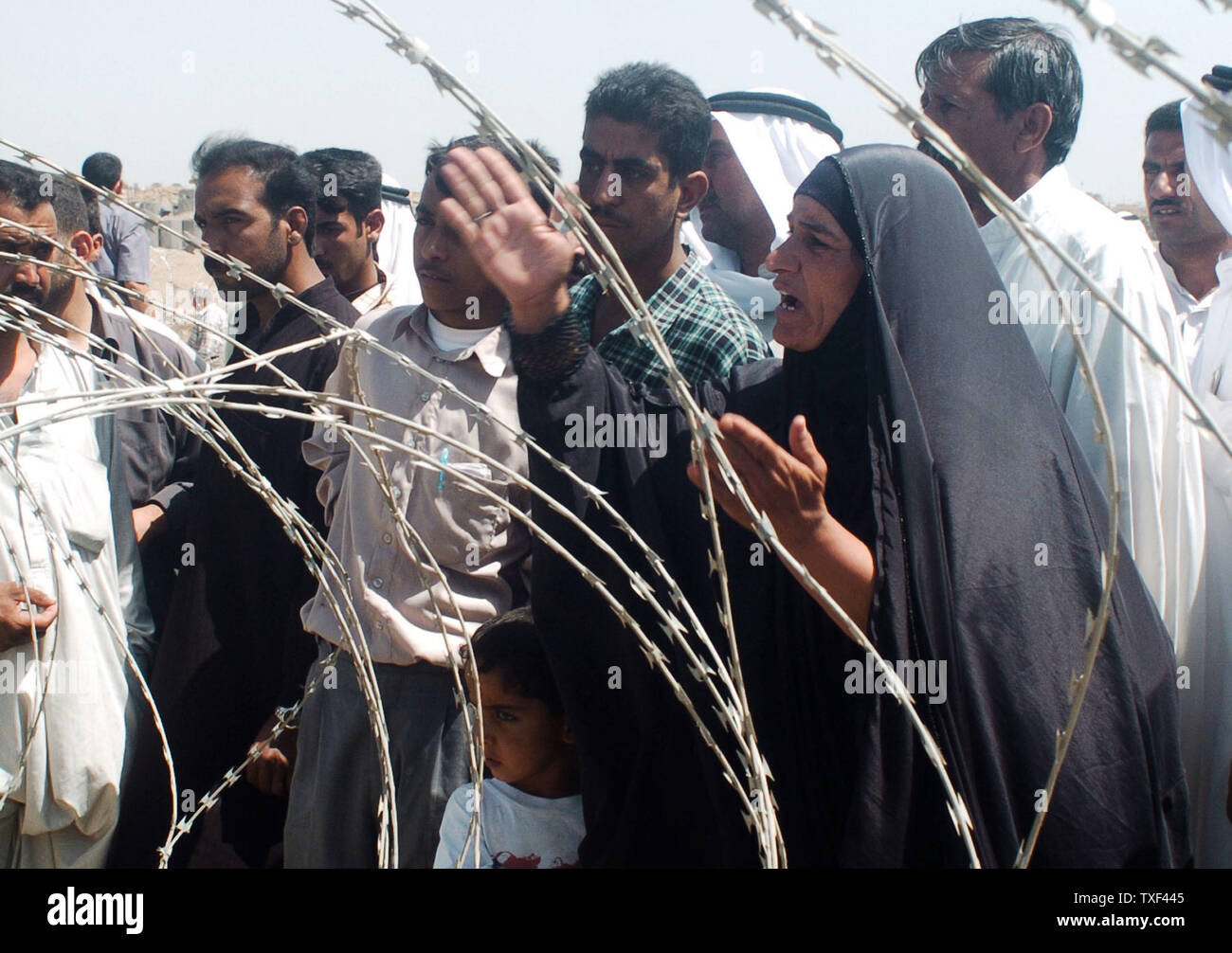 An Iraqi woman complains about the situation of her husband who was arrested 20 days ago outside of the Abu Ghraib prison on May 4, 2004 In Baghdad.   Hundreds of Iraqis waited outside the prison for news about their relatives.  The U.S. military's abuse of Iraqi prisoners was not an isolated incident, according to some members of the U.S. Congress.  (UPI Photo/Hugo Infante) Stock Photo