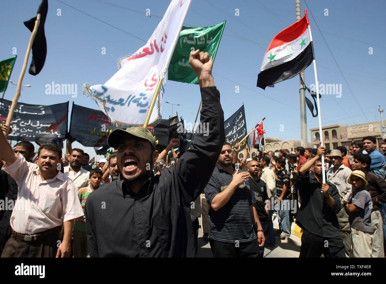 Iraqi Shiite Muslims take to the streets of Baghdad's Sadr City to protest yesterday's bombing of the Golden Mosque in Samarra on Thursday June 14, 2007. Sunni extremist linked to Al Qaida are blamed for the attack on one of Shiite's holiest shrines. (UPI Photo/Adel Abd Al-Hassan) Stock Photo