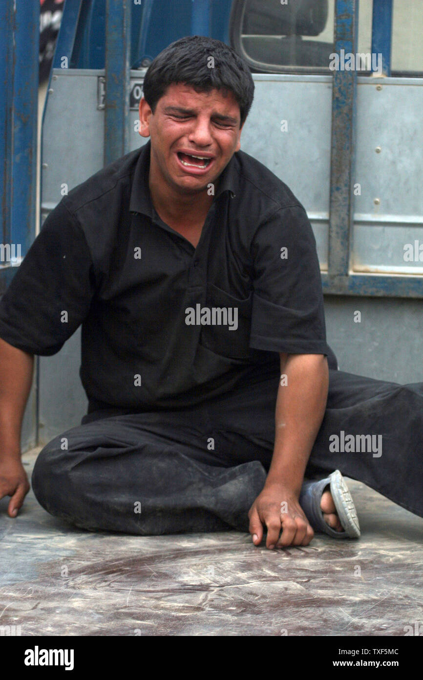 Iraqi man grieves at a funeral of a victim of a car bomb explosion in