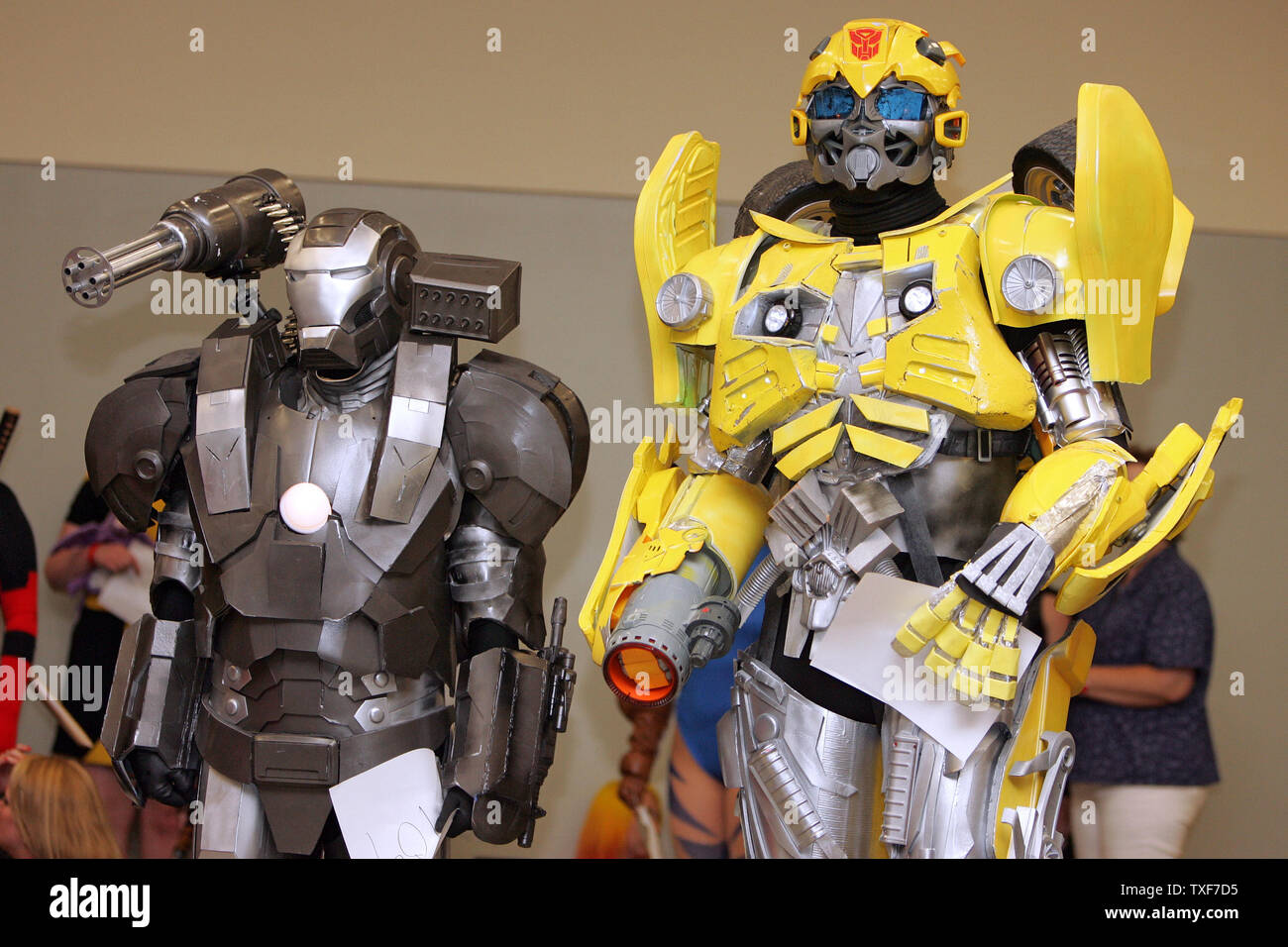 Eric Geisendaffer, dressed as War Machine from IronMan, and Paul Day,  dressed as BumbleBee from Transformers, stand in line to be judges for the  costume contest during the 11th annual Comic Con