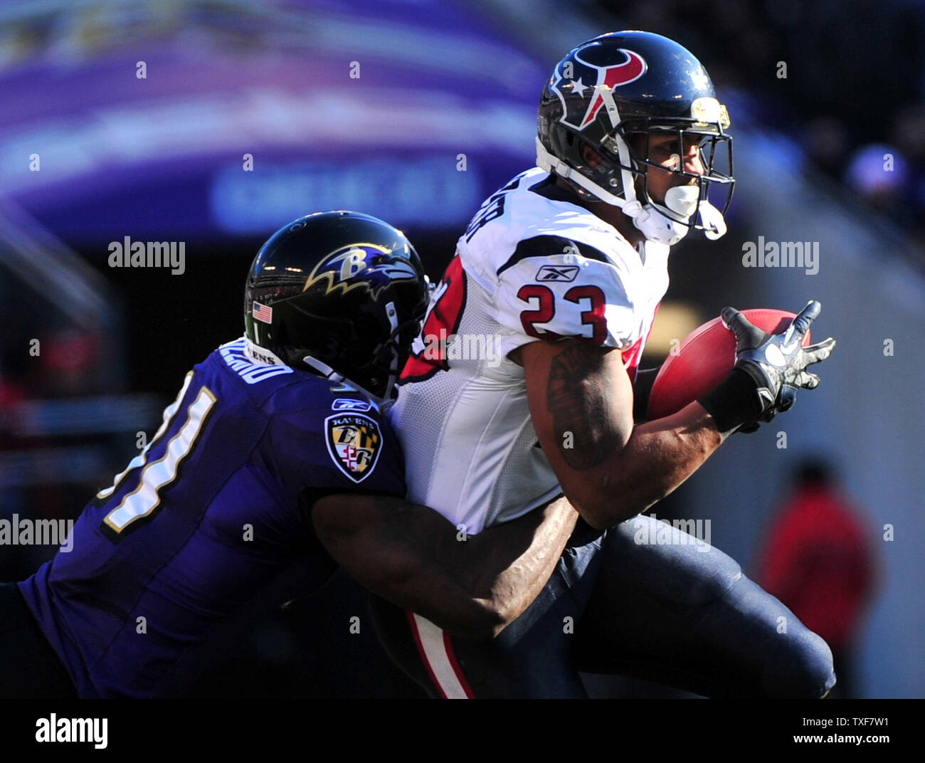 Houston Texans' Arian Foster is stopped for a loss by Baltimore Ravens Lardarius Webb during the first quarter at M&T Bank Stadium in Baltimore, Maryland on January 15, 2012.  UPI/Kevin Dietsch Stock Photo