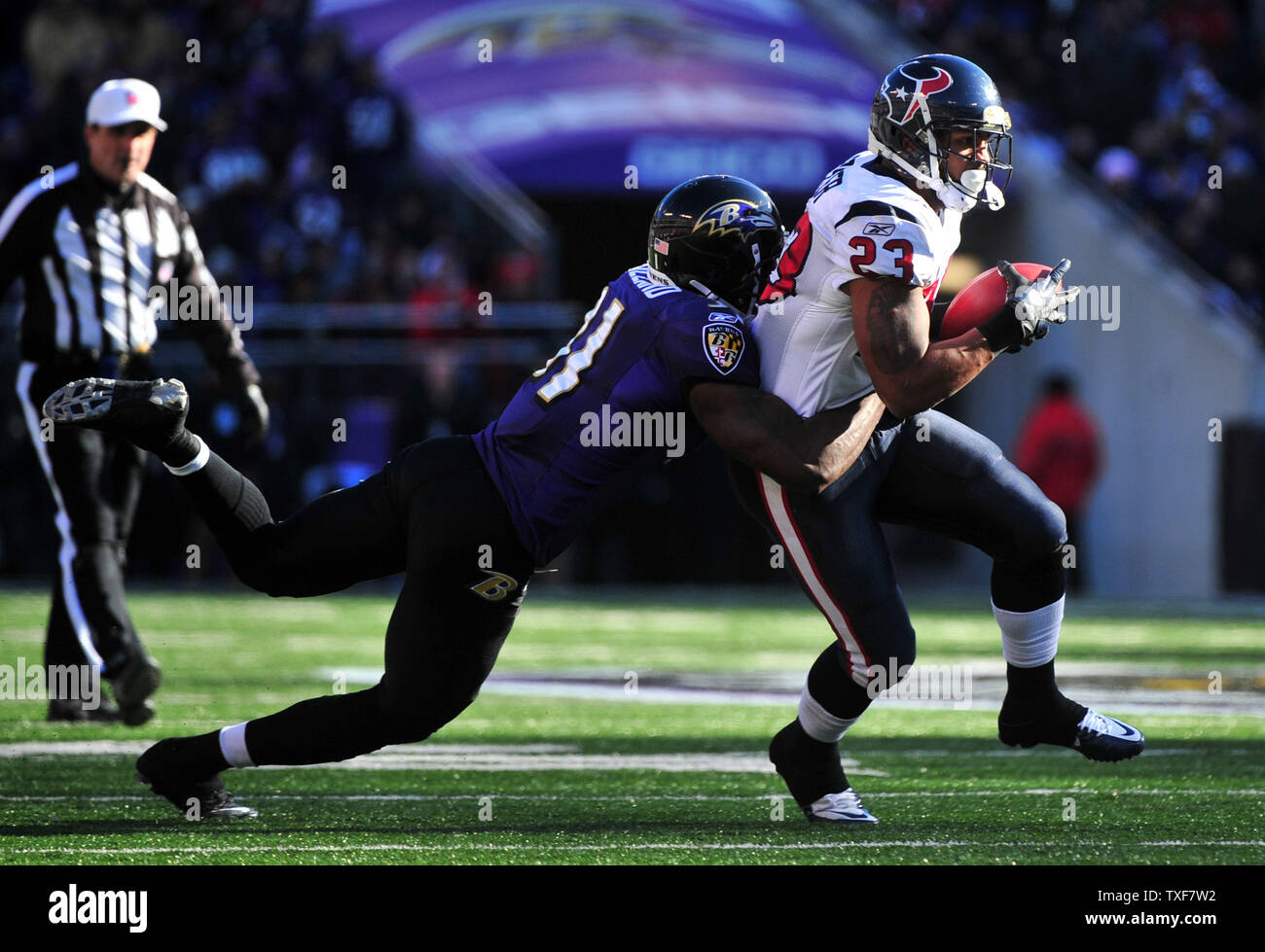 Houston Texans' Arian Foster is stopped for a loss by Baltimore Ravens Lardarius Webb during the first quarter at M&T Bank Stadium in Baltimore, Maryland on January 15, 2012.  UPI/Kevin Dietsch Stock Photo