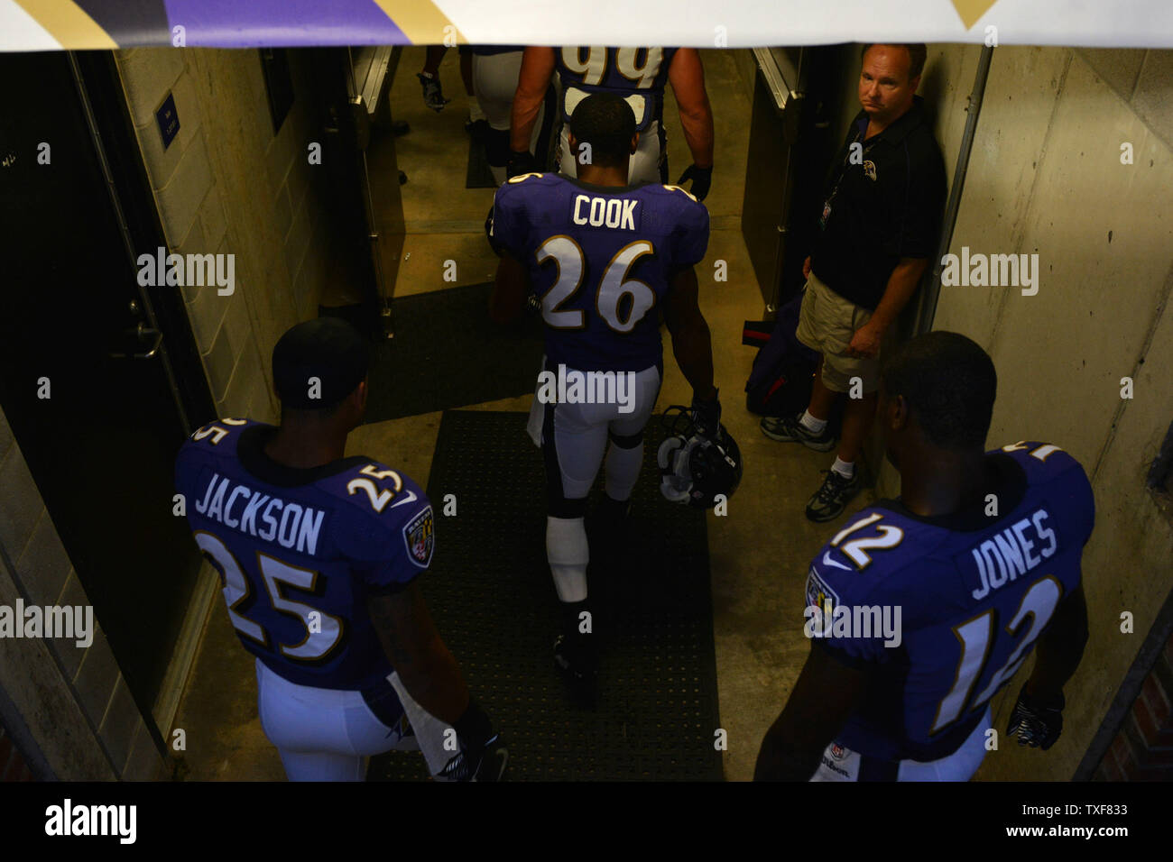 Members Of The Baltimore Ravens Walk Into The Locker Room As