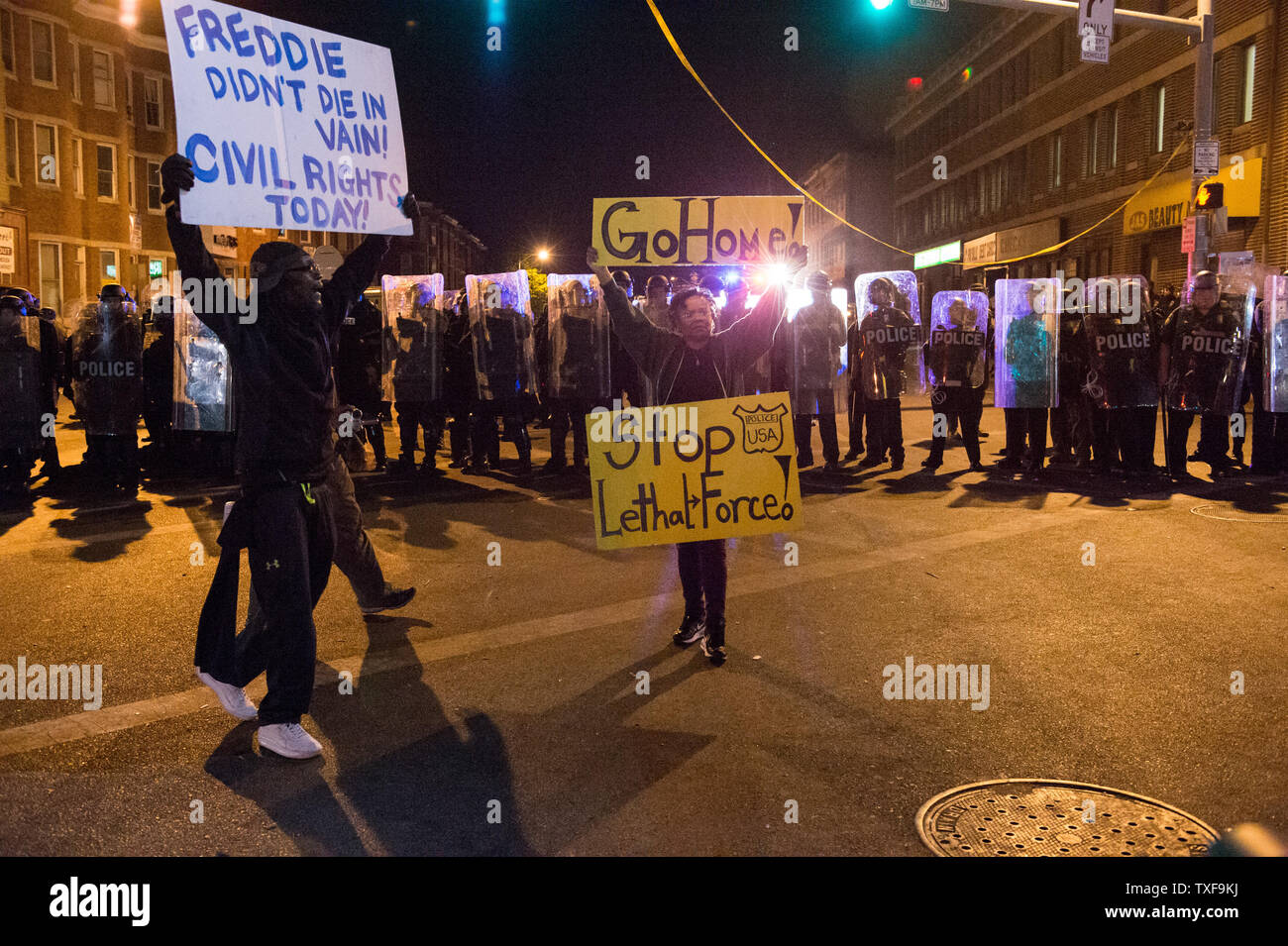 Protestors holds signs on Pennsylvania Ave as the 10 p.m. curfew approached in Baltimor, Maryland on April 28, 2015.  Protests have erupted after death of Freddie Gray.    Photo by Ken Cedeno/UPI Stock Photo