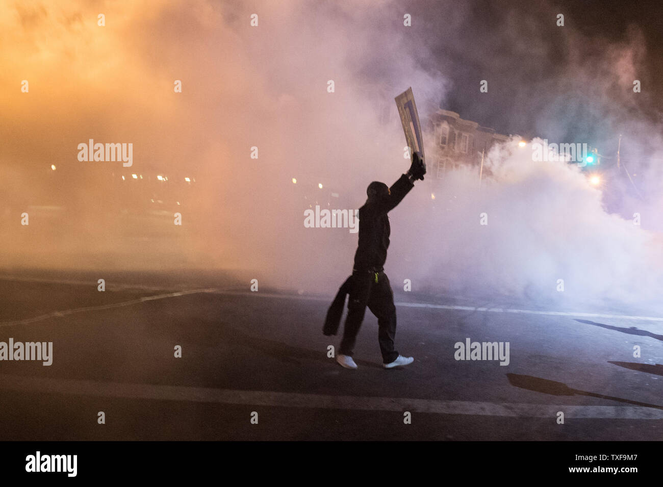 Smoke is used during demonstrations in Baltimore, Maryland after the 10 p.m. curfew passed on April 28, 2015.  Protests have erupted after death of Freddie Gray.    Photo by Ken Cedeno/UPI. Stock Photo