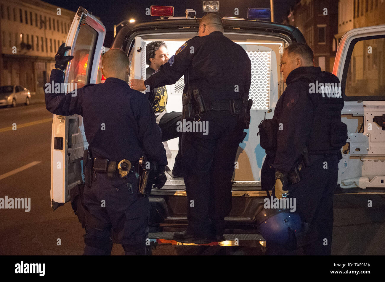 A man is arrested and taken to central booking for violating curfew near the corner of Pennsylvania Ave and North Ave in Baltimore, Maryland after the 10 p.m. curfew passed on April 28, 2015.  Protests have erupted after death of Freddie Gray.    Photo by Ken Cedeno/UPI Stock Photo
