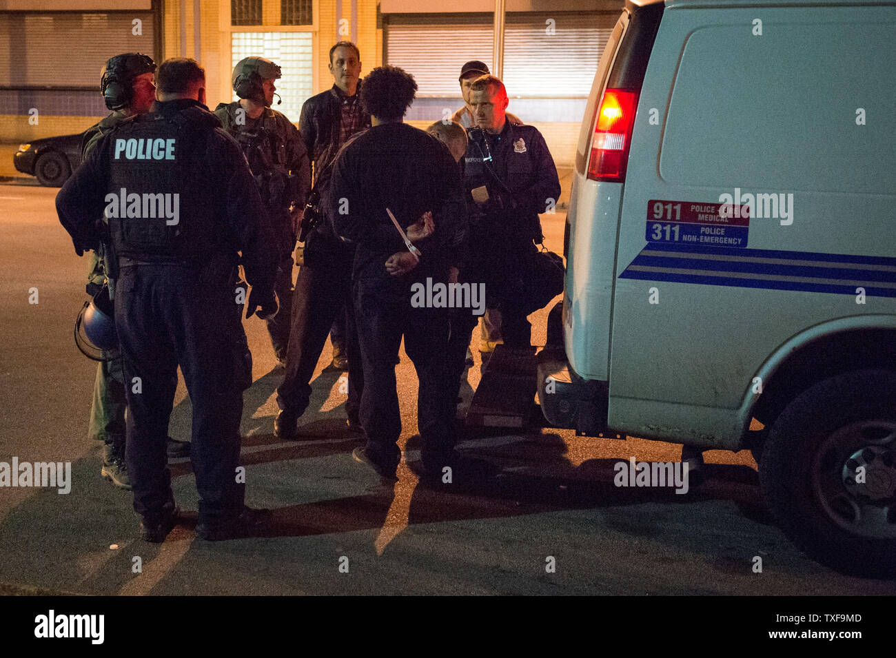 A man is arrested and taken to central booking for violating curfew near the corner of Pennsylvania Ave and North Ave in Baltimore, Maryland after the 10 p.m. curfew passed on April 28, 2015.  Protests have erupted after death of Freddie Gray.    Photo by Ken Cedeno/UPI Stock Photo